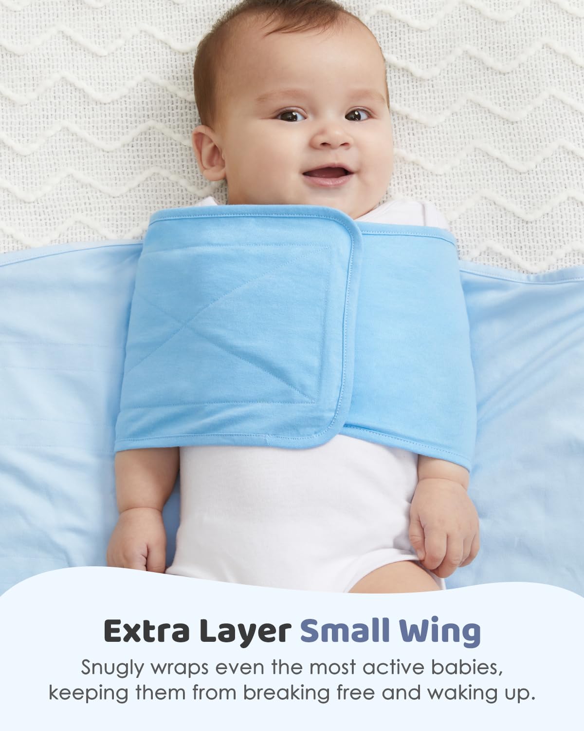 Smiling baby in Grownsy pink cotton swaddle sack, velcro closure, secure for newborns 0-6 months.