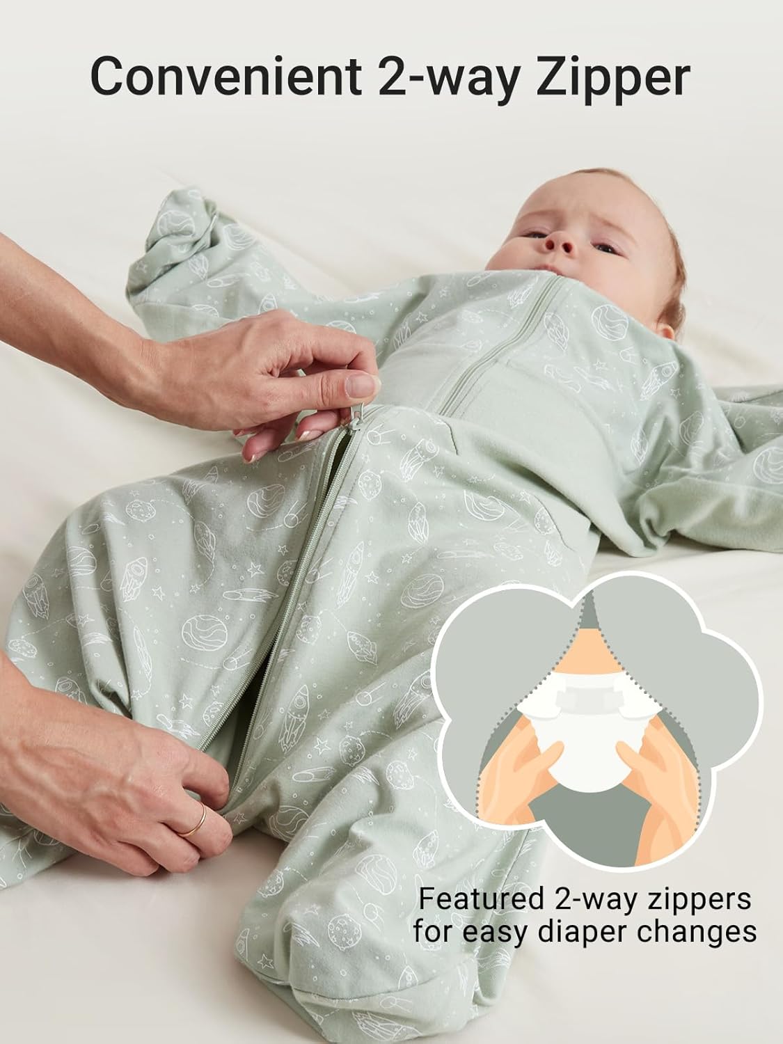 Baby in pale green cotton swaddle sack with 2-way zipper for easy diaper changes.