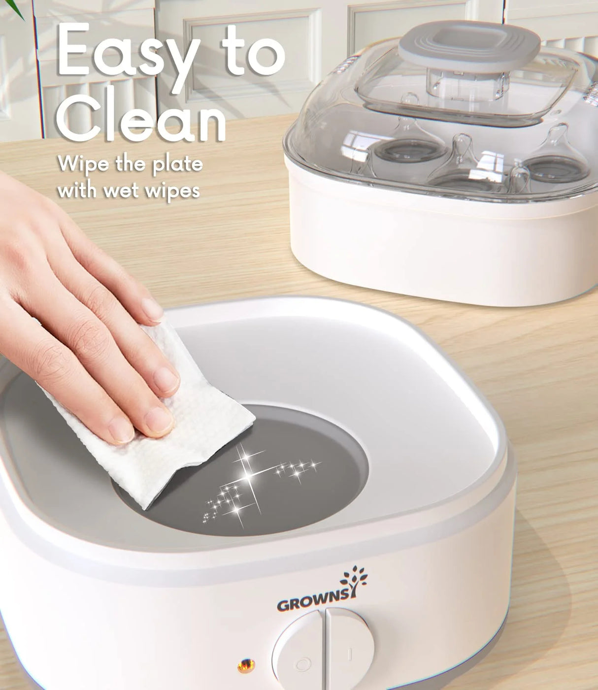 Hand wiping heating plate of white Grownsy baby bottle sterilizer, easy cleaning feature.