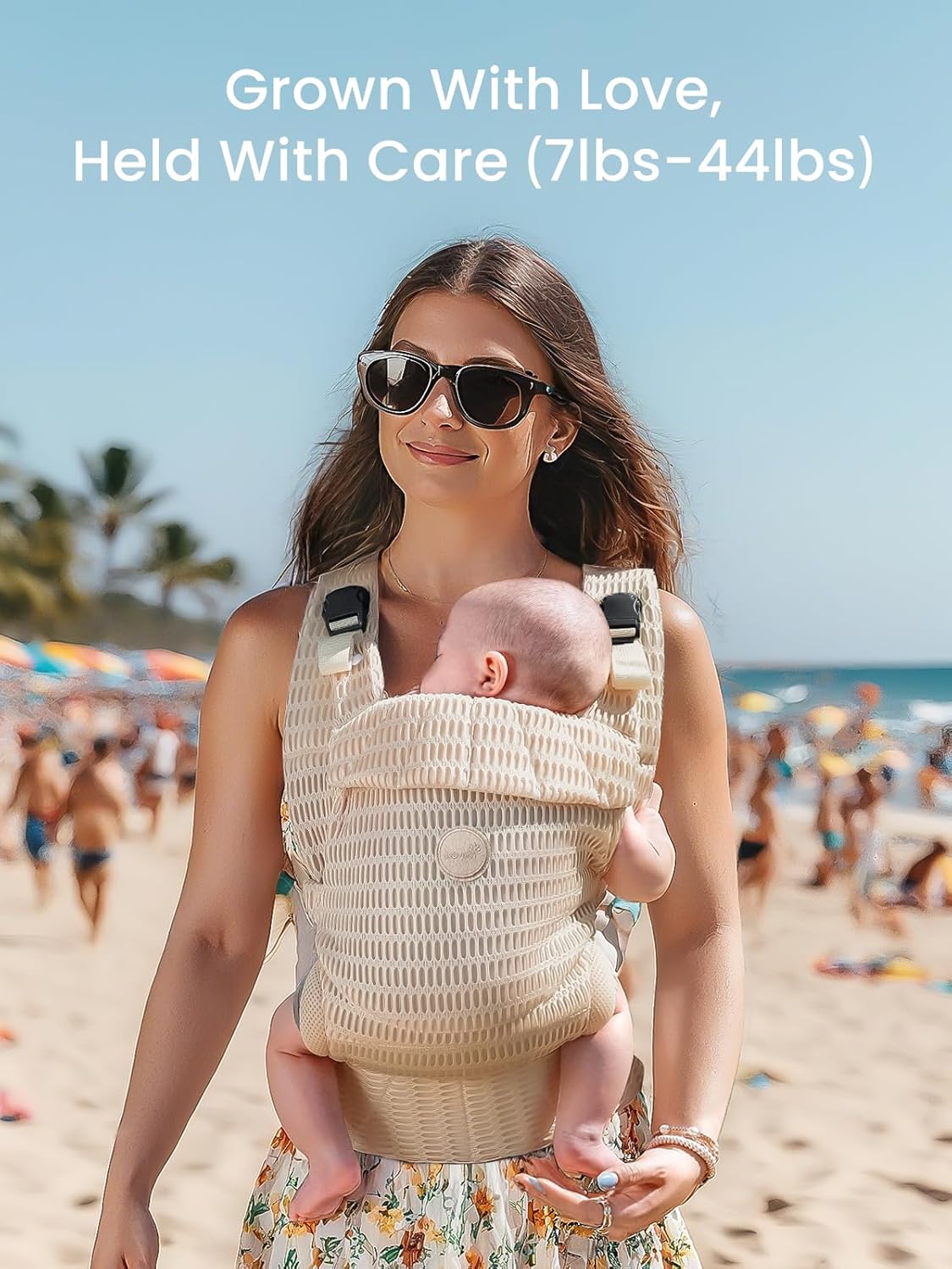 Light beige mesh ergonomic baby carrier on woman with baby at the beach, ideal for summer.
