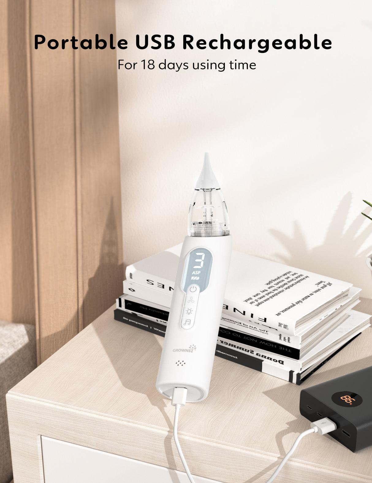 White portable USB nasal aspirator charging from power bank, showing digital display with suction level '3' and music icon.