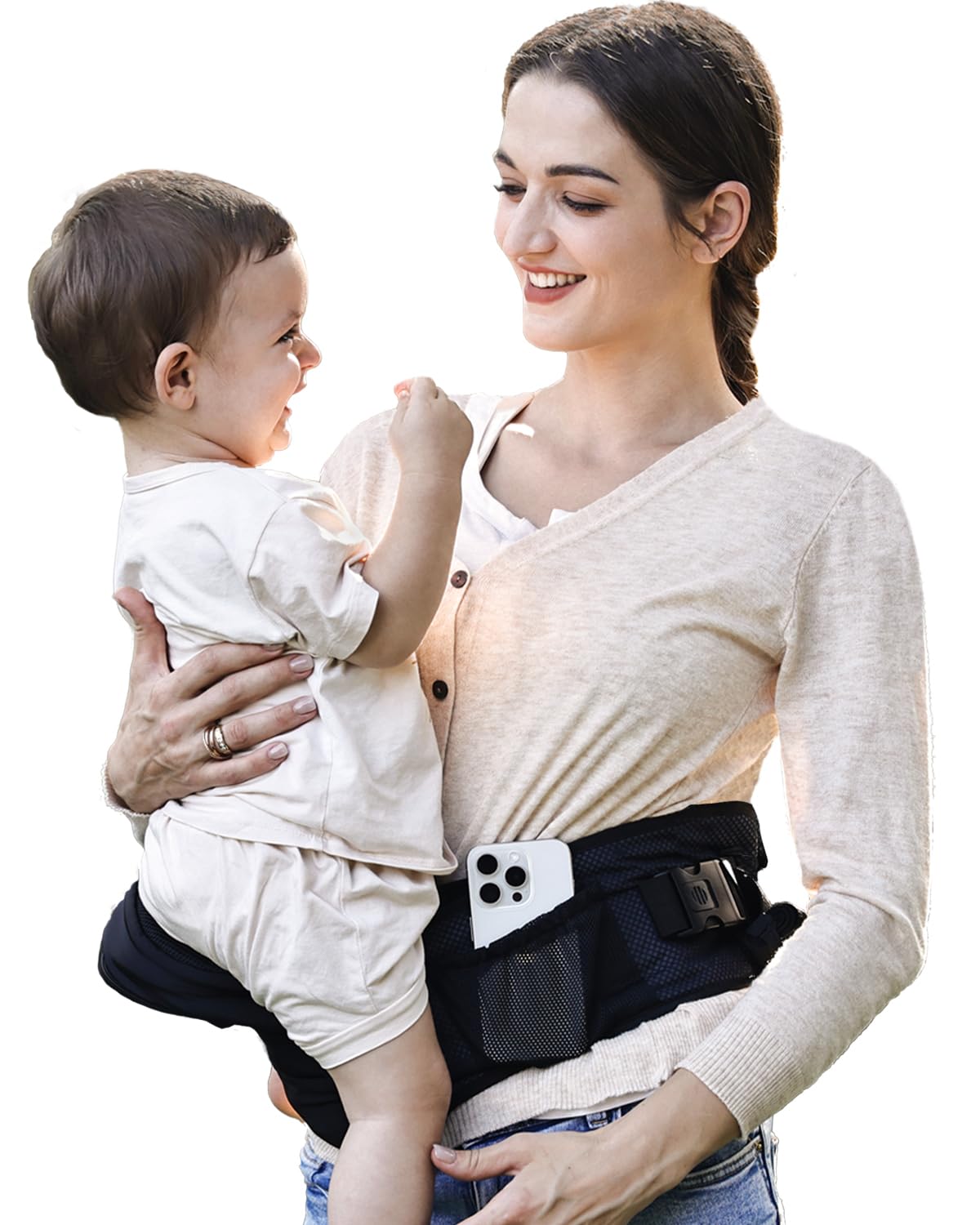 Smiling woman carries baby in black ergonomic hip seat carrier with phone pocket and mesh storage.