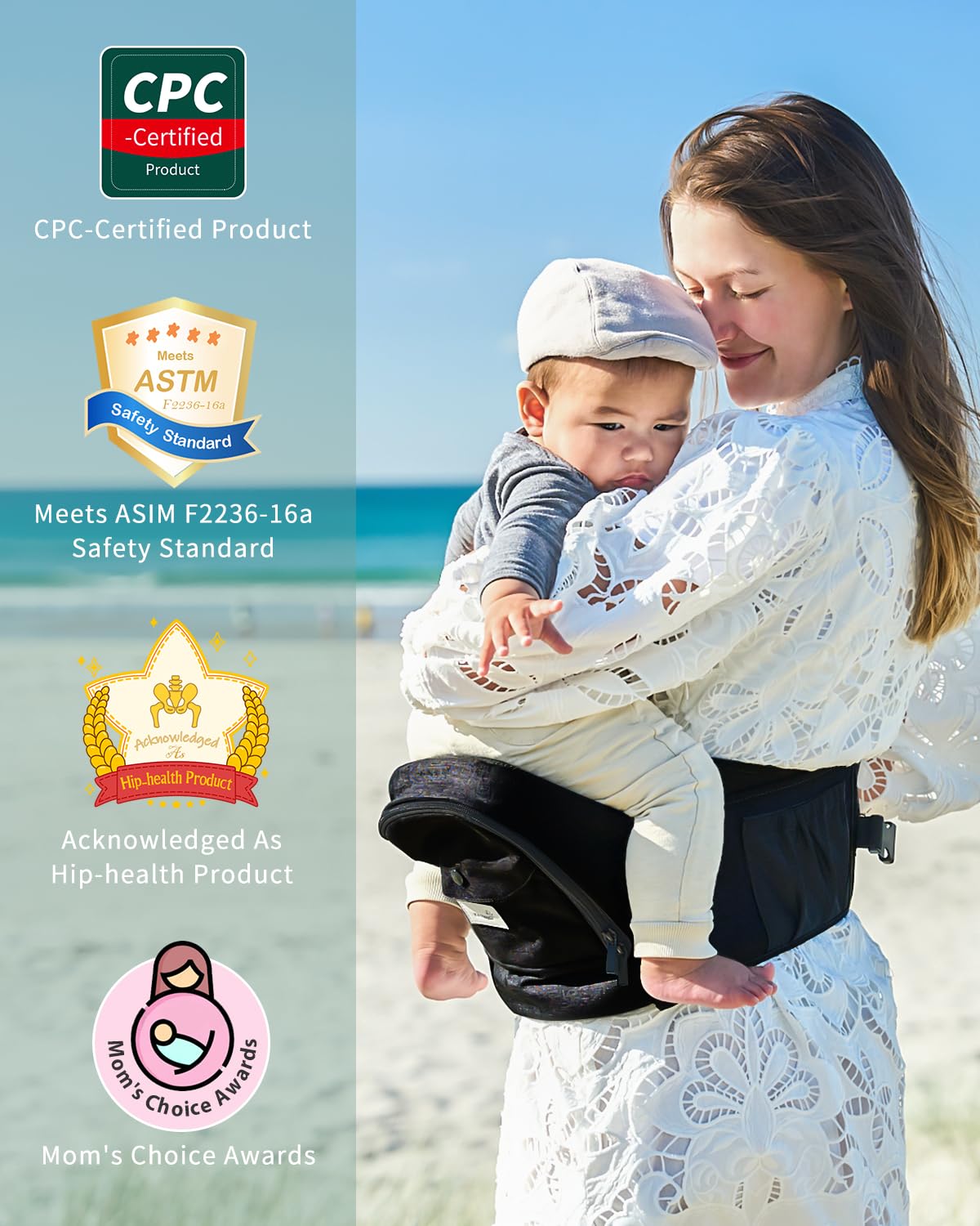 Black ergonomic hip seat carrier with safety certs. Woman holding baby on beach.