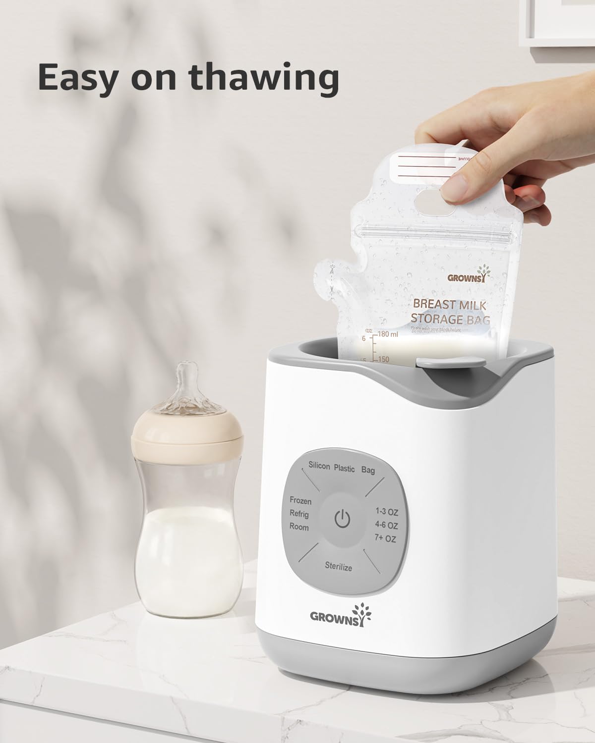 GROWNSY 10-in-1 baby bottle warmer demonstrating thawing function, with hand placing breast milk bag into device.