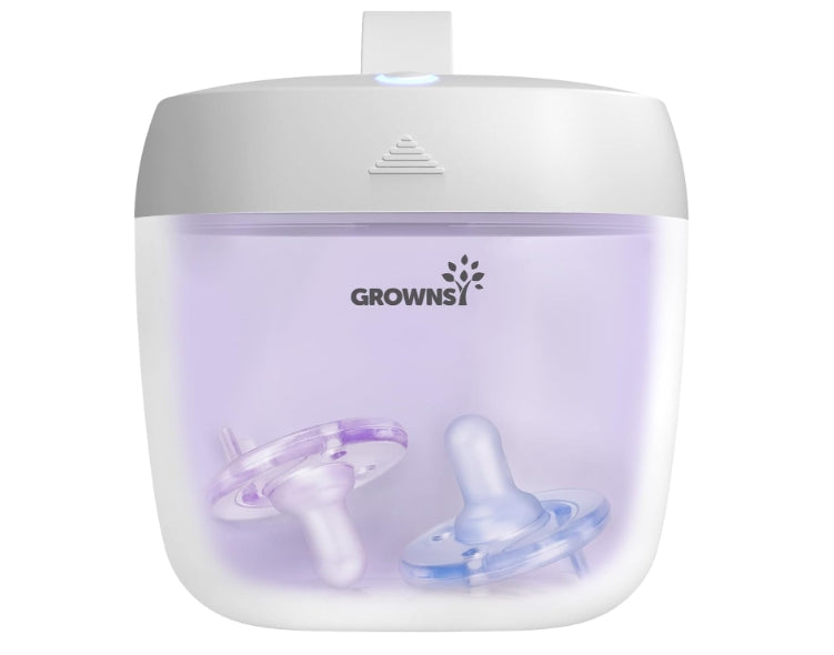 White GROWNSY MiniPure UV Sanitizer with two pacifiers (pink-purple and blue) inside illuminated interior.