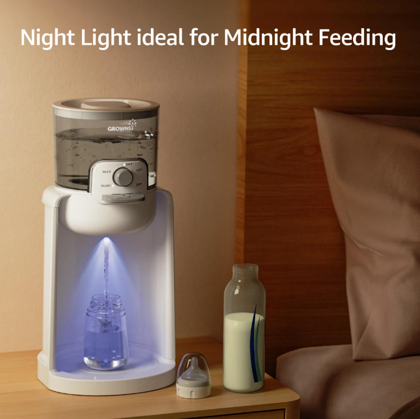 White instant baby bottle warmer with night light dispenses warm water into bottle on nightstand for midnight feeding.