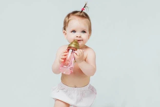 baby-holding-own-bottle