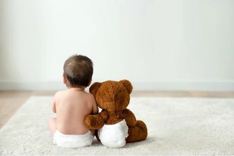 baby and toy bear