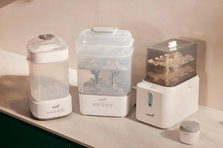 Baby bottle cleaning system with washer, sterilizer, and warmer placed on a table for daily feeding routines