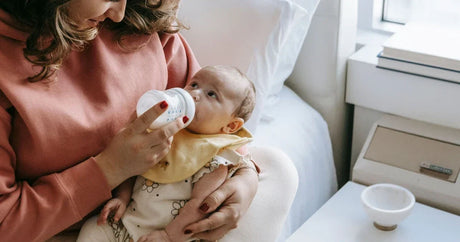 Mother bottle-feeding her baby during formula combo feeding.